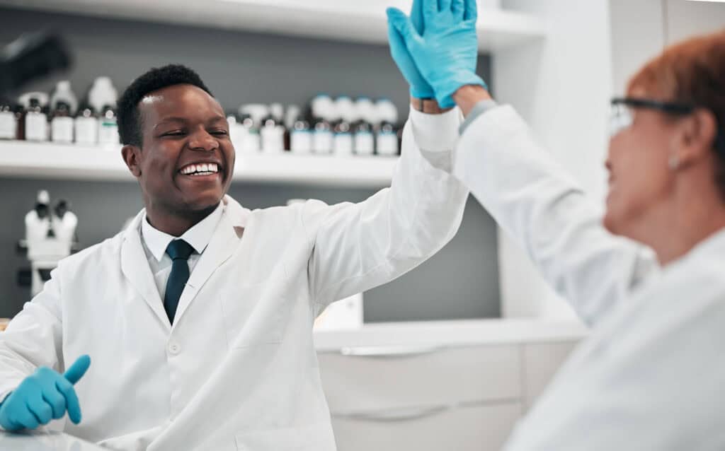 scientist teamwork man and woman with high five 2023 11 27 05 08 18 utc