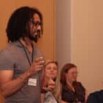 The Complete Guide to Crafting Powerful Value Propositions for Consultants (With Examples) Consultant explaining value propositions and sharing examples of his value proposition to a mastermind group of consultants.