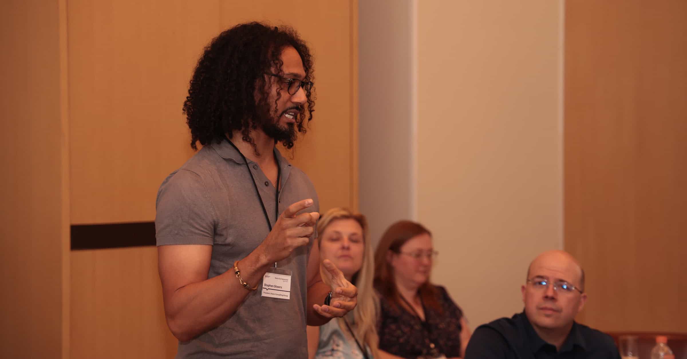 Consultant explaining value propositions and sharing examples of his value proposition to a mastermind group of consultants.