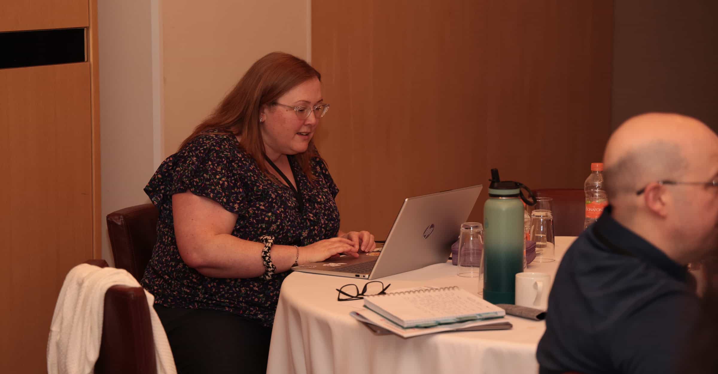 consultant sitting and looking at crm software on her laptop for her consulting business