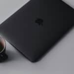 Personal Branding For Consultants: Be Authentic To Get More Clients laptop with recognizable brand on table with coffee mug