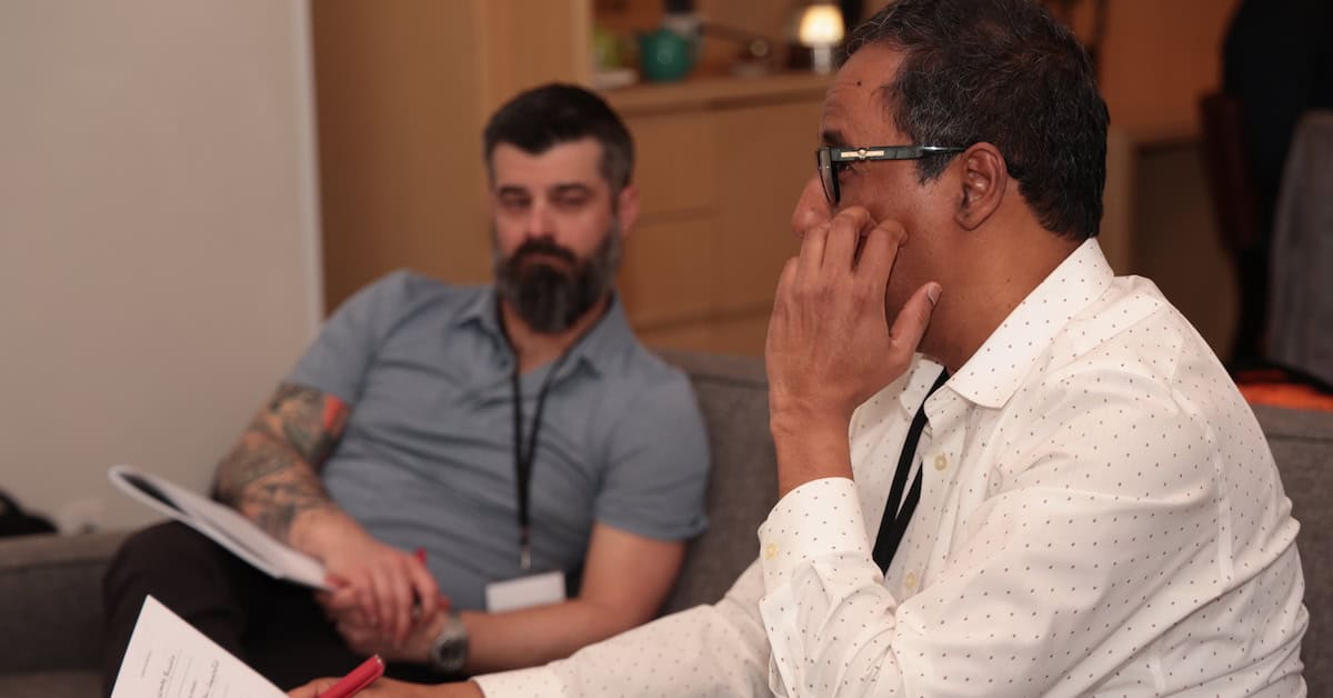 Consultant presenting productized offer with another consultant watching