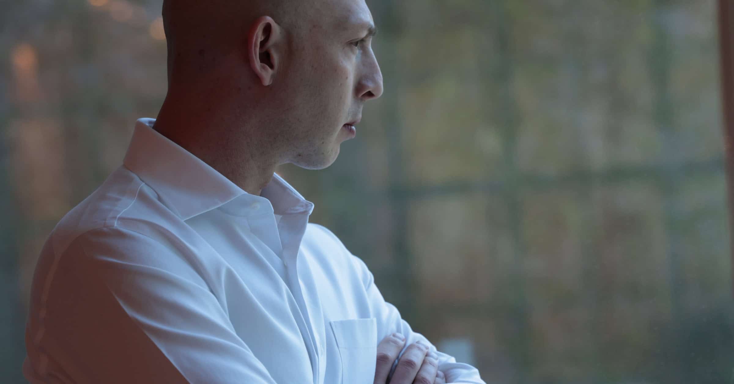 7 figure consultant looking out the window and thinking about business.