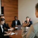 Professional consultants collaborating around conference table discussing different types of consulting specializations and business strategies