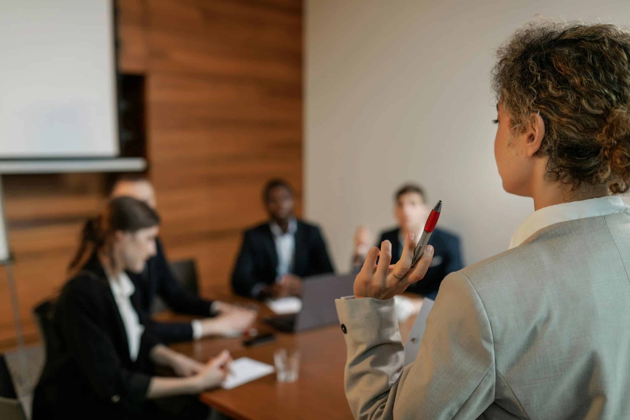 Professional consultants collaborating around conference table discussing different types of consulting specializations and business strategies