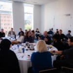 Consultants seated at round tables during a Consulting Success Inner Circle peer group session at the Montreal Mastermind Retreat.