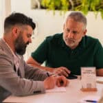 The Hidden Cost Of Saying Yes To Every Client A consultant reviewing prospects and choosing which clients to take on, illustrating selective client selection over a full calendar.