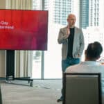 How to Set a Consulting Hourly Rate (And What To Do Instead) Michael Zipursky speaking at a consulting mastermind on how to set fees