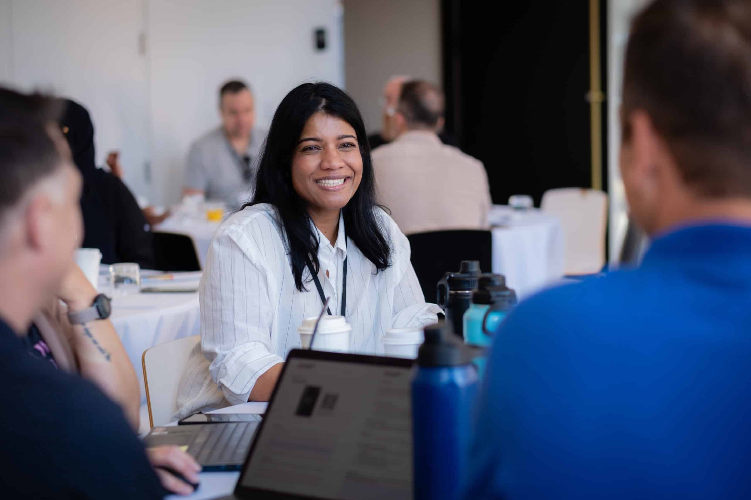 Consultant smiling during a group working session at a Consulting Success event